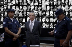 Rios Montt with his victims in the photos behind  Photo Credit  Gabriela Alvarez Castaneda