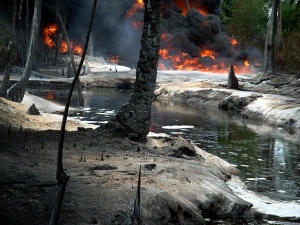 Oil from a leaking pipeline burns in Goi-Bodo, a swamp area of the Niger Delta in Nigeria October 12, 2004. Oil company Royal Dutch Shell said the leak was caused by unknown saboteurs on Monday who used a hacksaw to cut open a major pipeline feeding oil to an export terminal at Bonny, southern Nigeria. The fire was still raging on Wednesday, but the company said the impact on oil output was minimal. Picture taken October 12, 2004. REUTERS/Austin Ekeinde Pictures of the Month October 2004 TA/RSS/WS - RTRDAI9