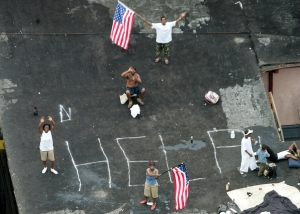 Residents wait on a rooftop to be rescued from the floodwaters of Hurricane Katrina on Sept 1, 2005 Photo by STR Reuters