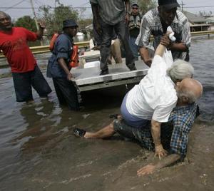 Woman collapses while residents attempt to rescue her and husband from flood waters in the aftermath of Hurricane Katrina Photo source AFP