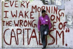 Every morning I wake up on the wrong side of Capitalism. Source Street Art, Open Democracy.