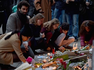 PARIS, FRANCE - NOVEMBER 14: Mourners gather in front of the Petit Cambodge and Le Carillon restaurants on November 14, 2015 in Paris, France. At least 120 people have been killed and over 200 injured, 80 of which seriously, following a series of terrorist attacks in the French capital. (Photo by Jeff J Mitchell/Getty Images)